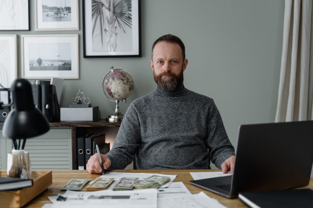 man-sitting-with-currency